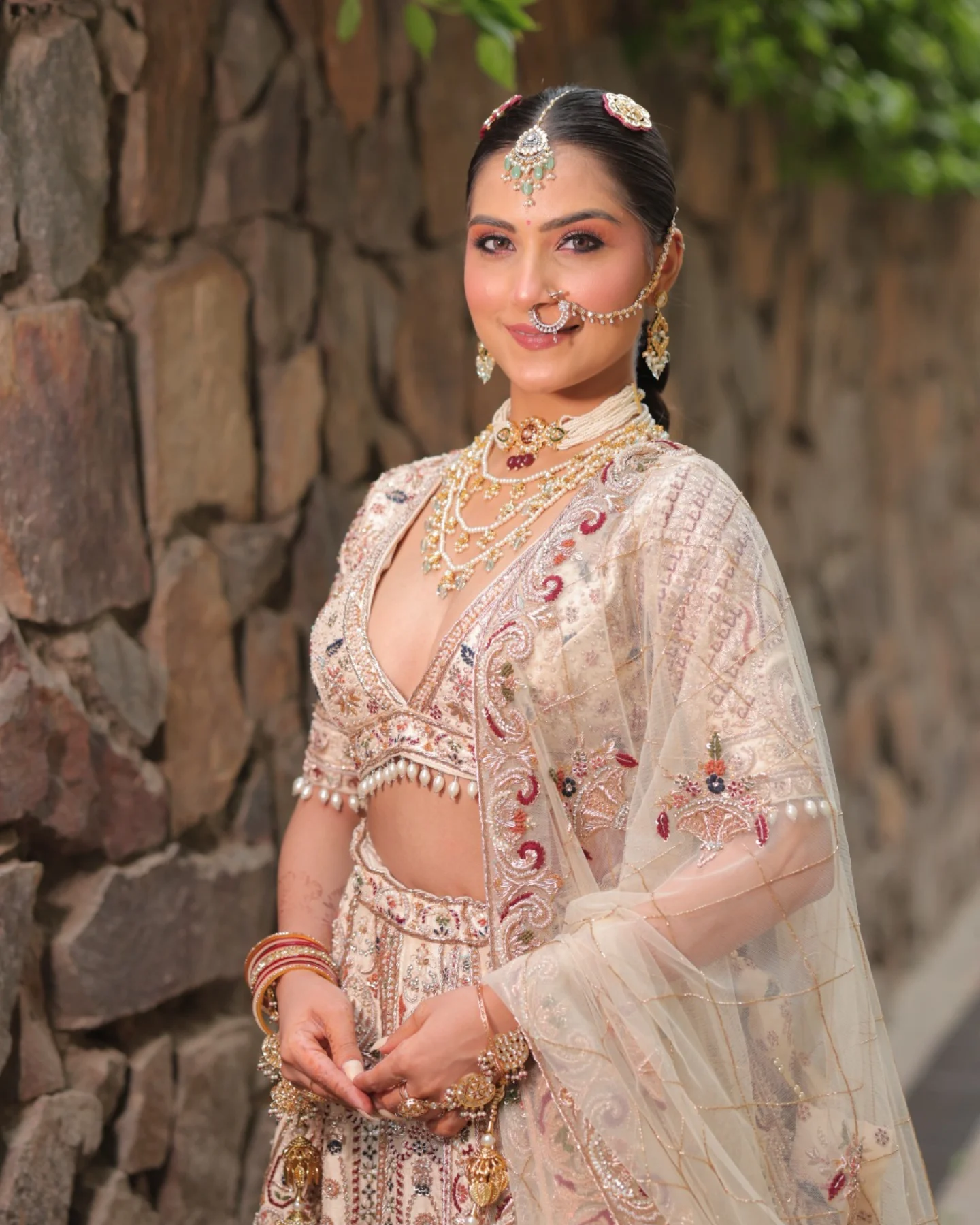 Bride in pastel pink lehenga with soft glam makeup